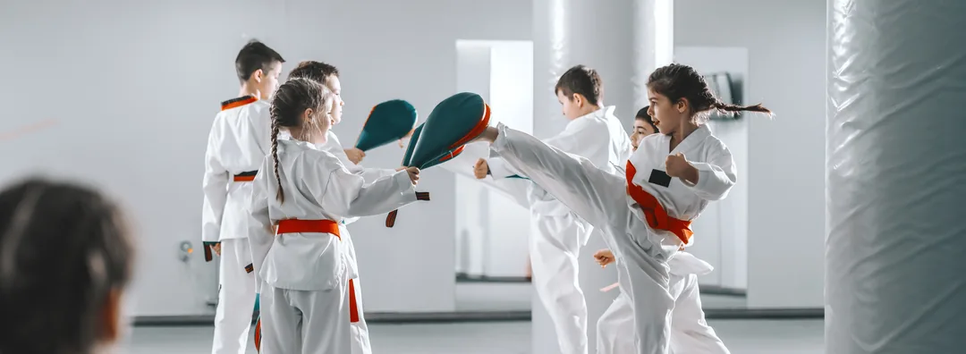 A Taekwondo class in a bright studio