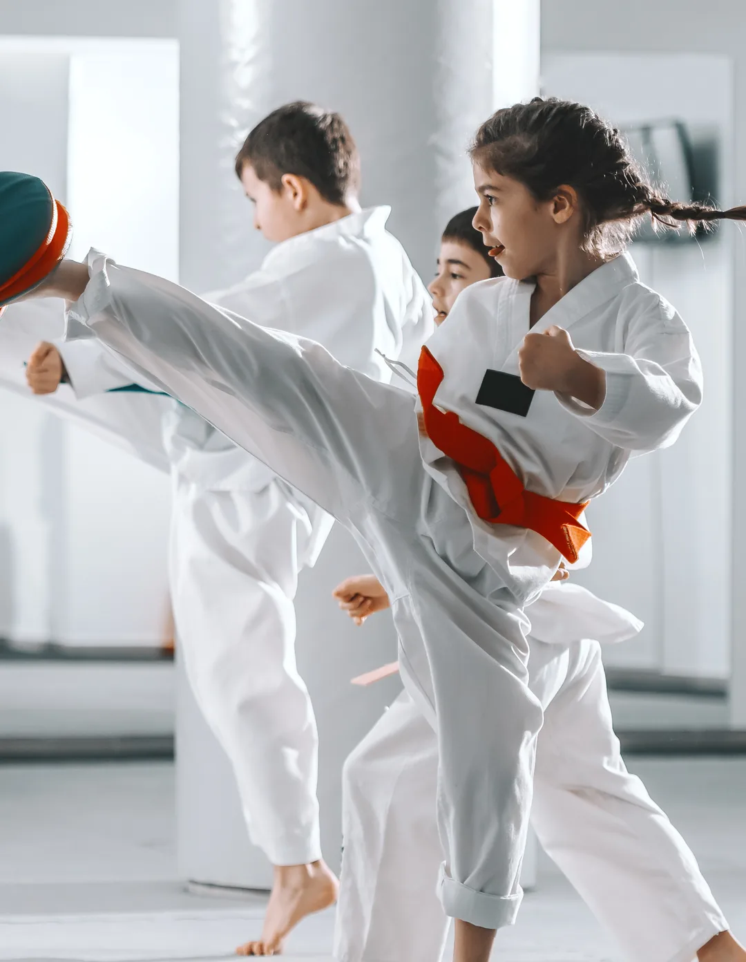A girl mid-kick, eyes on the target